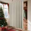 A room decorated for Christmas with a Christmas tree, gifts, and a large beige curtain acting as a room divider. A closet is visible behind the curtain. Produktbild-Vorschau