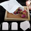 A close-up shot of empty tea bags and dried rose buds on a wooden tray. Produktbild-Vorschau