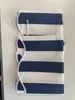 A folded striped awning valance lies on a white surface. Produktbild-Vorschau
