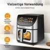 A close-up shot of a black and silver air fryer with a digital display, placed on a countertop. Produktbild-Vorschau