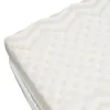 A close-up view of a white foam mattress with a textured surface. Produktbild-Vorschau