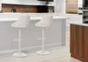 Two white bar stools in a modern kitchen setting. Náhľad obrázku produktu