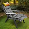 A gray chaise lounge cushion with a colorful pillow rests on a wooden lounge chair in a grassy, wooded area. Podgląd zdjęcia produktu