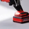 A close-up of the battery and base of a red and black power tool. Produktbild-Vorschau
