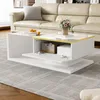 A modern white coffee table with storage, placed in a living room setting with a sofa and rug.