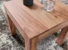 A close-up view of a wooden coffee table with two glasses and a dark vase on top. Náhled obrázku produktu