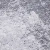 A close-up view of a textured rug with an abstract pattern. Produktbild-Vorschau
