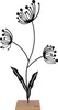 A black metal silhouette of a stylized flower with three seed heads and two leaves, standing on a light brown wooden base. Produktbild-Vorschau