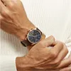 A close-up shot of a man's wrist wearing a Tommy Hilfiger Baker Herrenuhr watch. Produktbild-Vorschau
