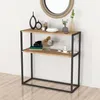 A console table with two shelves, decorated with various items, against a white wall. Náhled obrázku produktu
