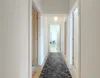 A hallway with a rug and several doors. Produktbild-Vorschau