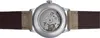 The back of a watch with its mechanical movement visible through a transparent case back. Voir les images du produit