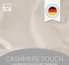 A close-up of a textured fabric with branding and marketing text overlays. Voir les images du produit