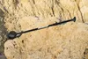 A paddleboard paddle rests on a rocky surface. Produktbild-Vorschau