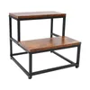 A two-step stool with a wood-grain finish and black metal frame, shown against a white background. Podgląd zdjęcia produktu