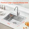 A stainless steel kitchen sink with a faucet, placed on a marble countertop. Podgląd zdjęcia produktu