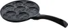 A close-up, angled view of a black non-stick frying pan with seven circular indentations, each designed to resemble a smiley face. Produktbild-Vorschau