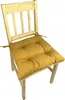 A yellow seat cushion on a wooden chair. Produktbild-Vorschau