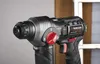 Close-up of a black and gray cordless drill with red accents, set against a neutral background. Produktbild-Vorschau