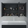 A dark gray bathroom cabinet with open doors, displaying various toiletries on its shelves, above a white sink. Produktbild-Vorschau