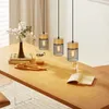 A dining table set with a pendant light fixture, flowers, books, and breakfast items. Anteprima dell’immagine prodotto