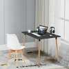 A modern desk setup with a laptop, headphones, and a chair in a room with natural light. Voir les images du produit