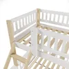 Close-up view of a white and natural wood bunk bed frame, showing the railing and ladder. Produktbild-Vorschau