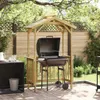 A wooden grill shelter with a barbecue grill set up in a backyard patio. Podgląd zdjęcia produktu