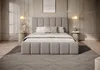 A modern bedroom with a large upholstered bed. Produktbild-Vorschau