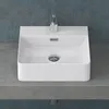 A white ceramic sink with a chrome faucet and drain, placed on a gray countertop against a blue textured wall. Produktbild-Vorschau