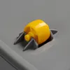 A close-up view of a yellow wheel attached to a gray plastic storage box. Produktbild-Vorschau