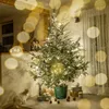 A Christmas tree decorated with lights and ornaments, standing in a room with a cat and gifts. Voir les images du produit