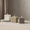 Three bubble candles in different colors are arranged on a white surface, with a draped curtain in the background. Podgląd zdjęcia produktu
