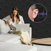 A woman is sitting on a couch using a laptop and holding a mug, with a graphic overlay showing an ear and sound waves. Produktbild-Vorschau