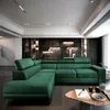 A modern living room featuring a large, plush green sectional sofa. Produktbild-Vorschau