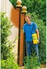 A man is spraying a wooden fence with a yellow spray bottle. Produktbild-Vorschau