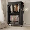 A portable wardrobe with clothes hanging on multiple racks and some storage boxes on the bottom shelf. The wardrobe has side pockets. Produktbild-Vorschau