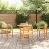 A wooden table and four chairs are set up on a paved patio in a garden setting, surrounded by lush greenery and a wooden fence. Anteprima dell’immagine prodotto