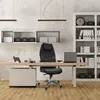 An office chair in a modern office setting with a desk, shelves, and lighting. Produktbild-Vorschau