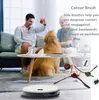 A family and their dog are in a living room, with a robot vacuum cleaner and its accessories in the foreground. Produktbild-Vorschau