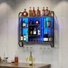 A wall-mounted wine rack with LED lighting, filled with various bottles of alcohol and glassware, displayed against a concrete wall. Produktbild-Vorschau