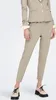 A person wearing beige pants and a beige blazer, standing against a white background. Produktbild-Vorschau