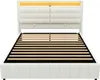 A white upholstered bed frame with a slatted mattress support and a lit headboard. Produktbild-Vorschau