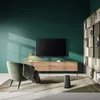 A modern living room with a TV, entertainment center, armchair, and bookshelf. Produktbild-Vorschau