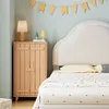 A bedroom corner with a bed, nightstand, and wall decor. Produktbild-Vorschau