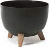 A black planter pot with three brown legs, isolated on a white background. Náhled obrázku produktu