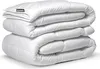 A stack of folded white duvets on a white background. Produktbild-Vorschau