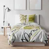 A bedroom scene with a bed, pillows, and a lamp. Anteprima dell’immagine prodotto