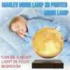 A child sleeping next to a levitating moon lamp. Náhled obrázku produktu