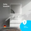 A modern white bathroom vanity with a mirror and sink, set against a gray wall. Promotional text and badges are overlaid on the image. Produktbild-Vorschau